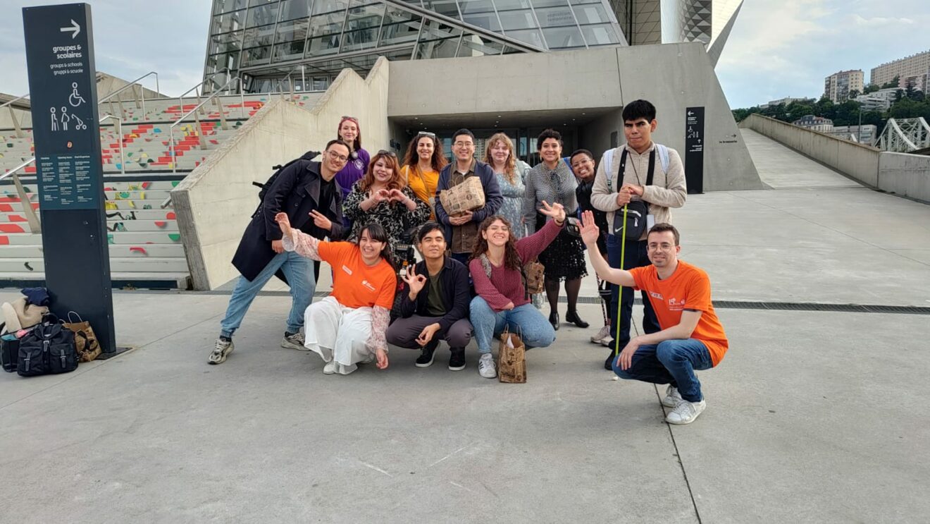 Decorative image of young persons with disabilities outside a museum.